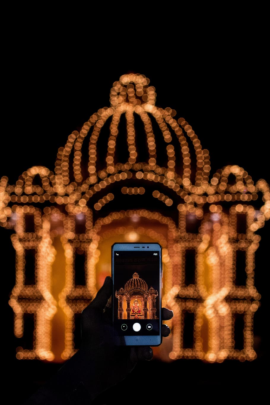 Person Taking Photo of String Light Decor With Smartphone during Nighttime HD wallpaper