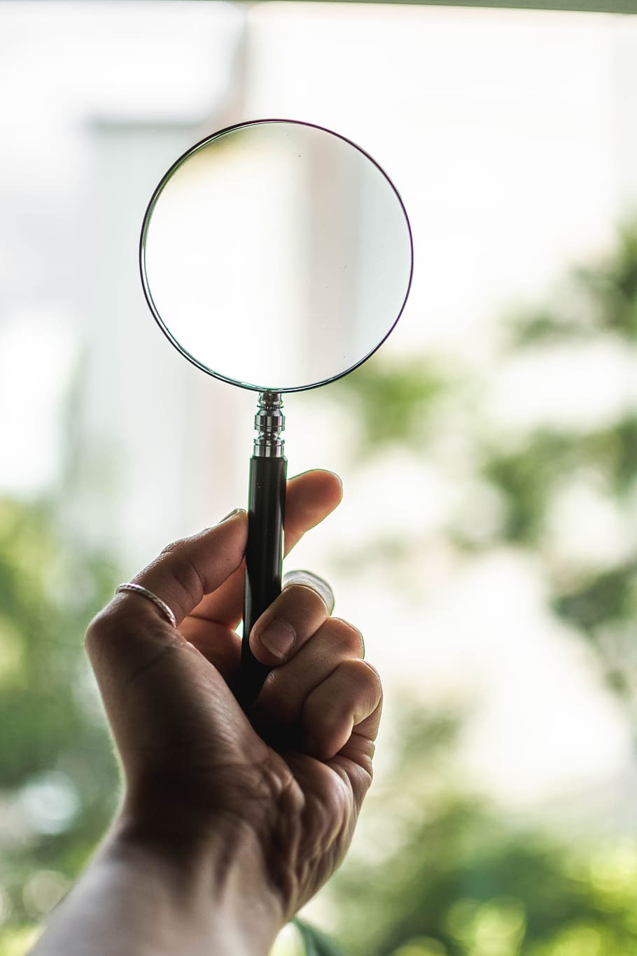 Tilt Shift Lens Photography of Person Holding Magnifying Glass HD wallpaper