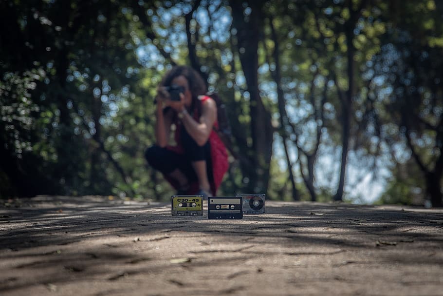 Two Cassette Tapes on Ground, blurred background, camera, camera lens HD wallpaper