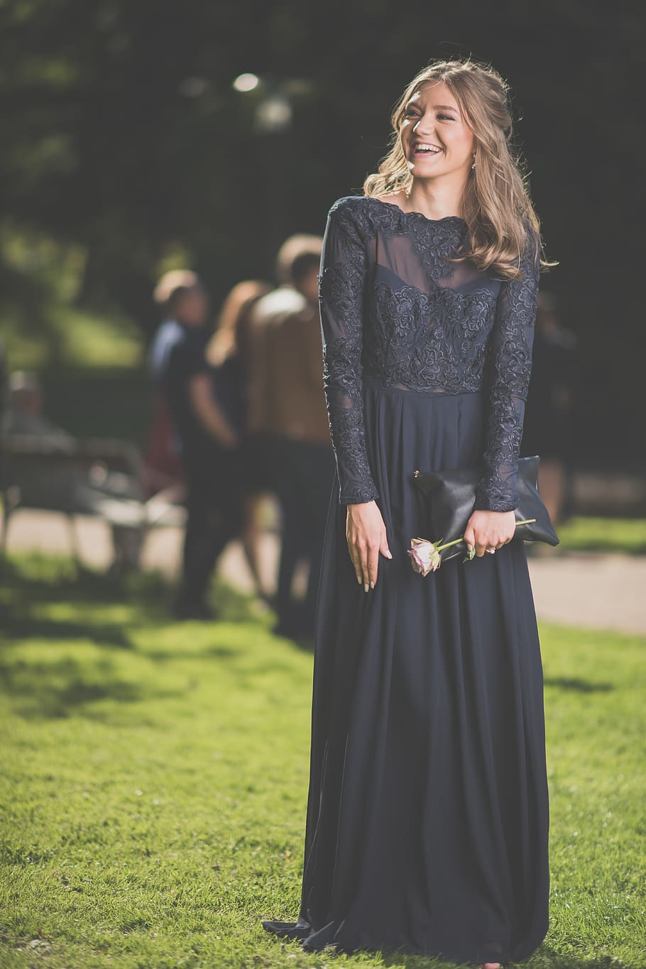 Woman in Black Floral Long-sleeved Dress While Smiling during Nighttime HD wallpaper