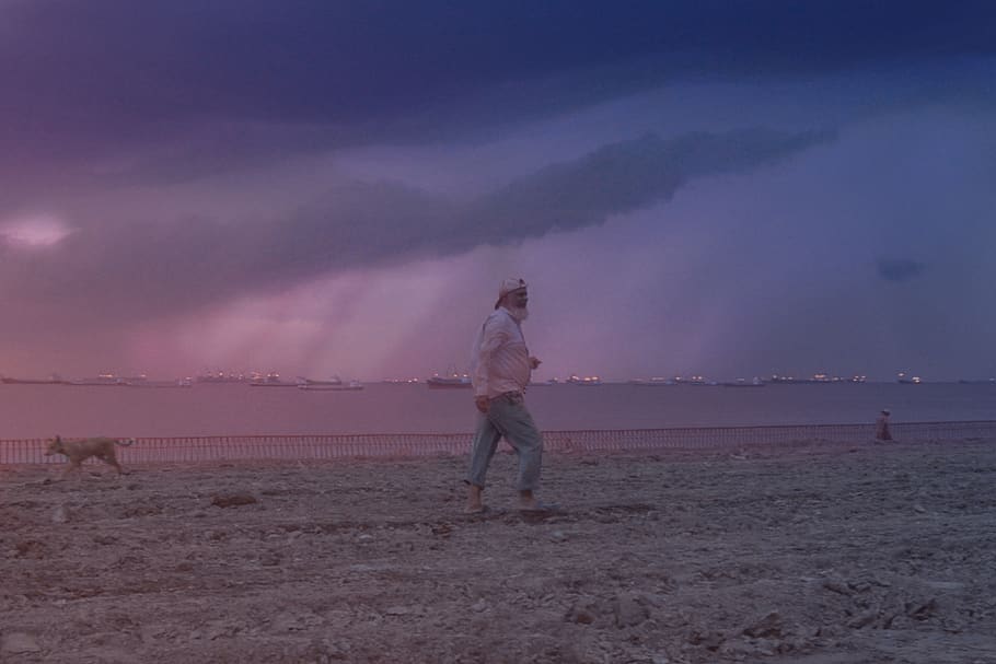 man walking on grass field, weather, nature, person, human, outdoors HD wallpaper