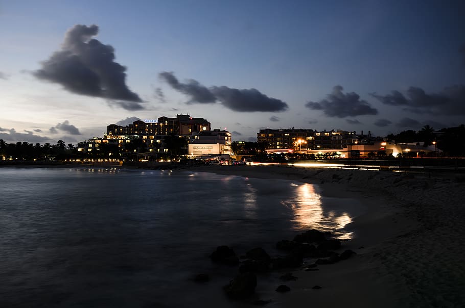 beach during nighttime, metropolis, building, town, urban, city HD wallpaper