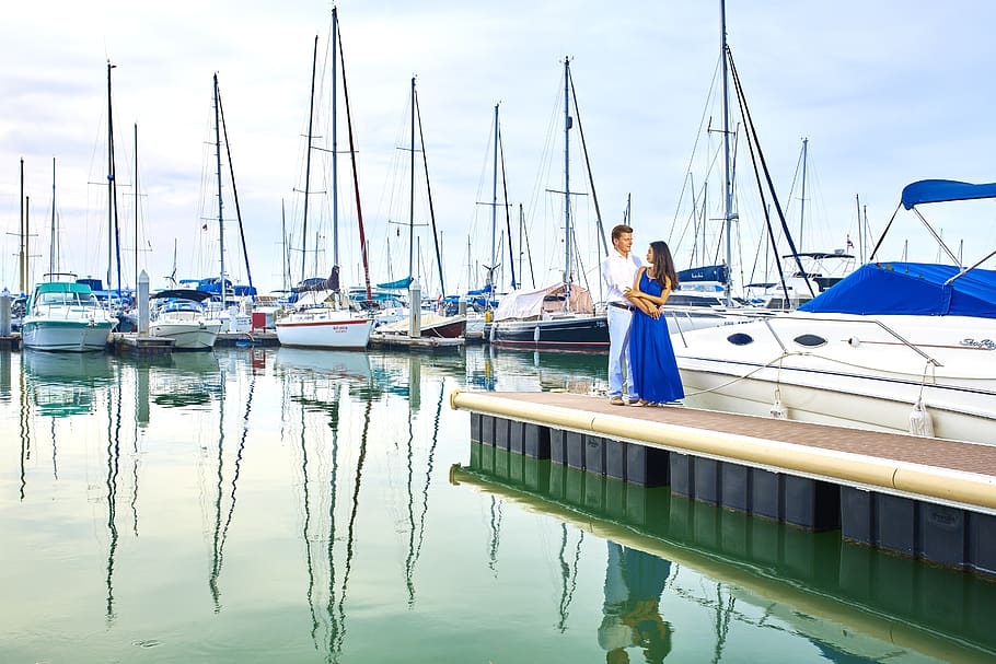 Man and Woman Standing Near Boat, bay, blur, boats, close-up