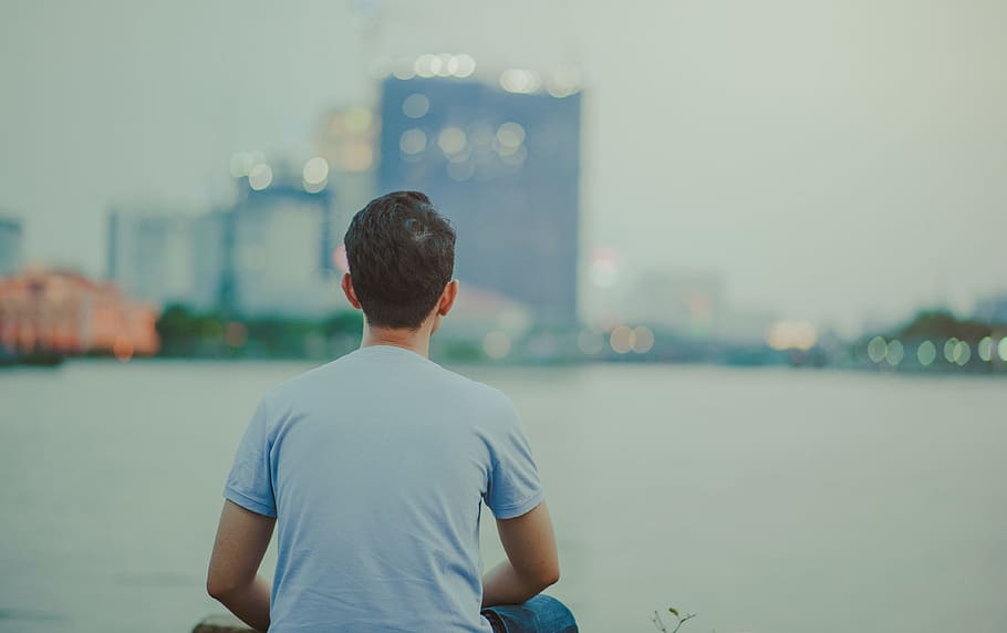 Photo of Man Wearing Blue Shirt Sitting Looking on High-rise Buildings HD wallpaper