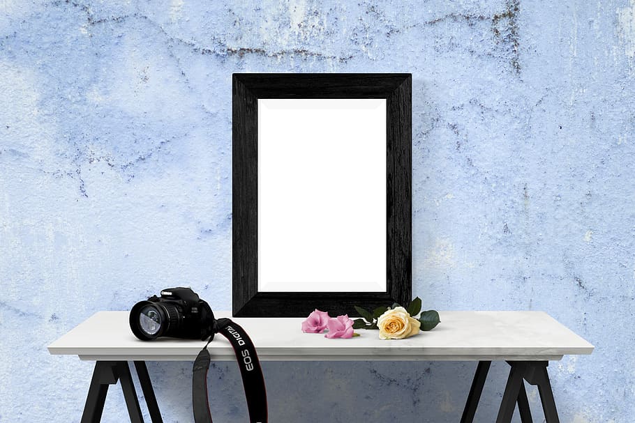 poster, frame, wall, desk, flowers, camera, table, technology