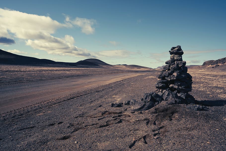 cairn stone during daytime, ground, road, gravel, iceland, soil