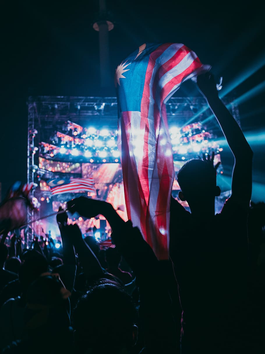 person holding Malaysian flag, independence day, light, concert