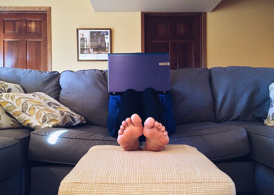 Person Sitting on Couch While Using Laptop Computer, apartment HD wallpaper