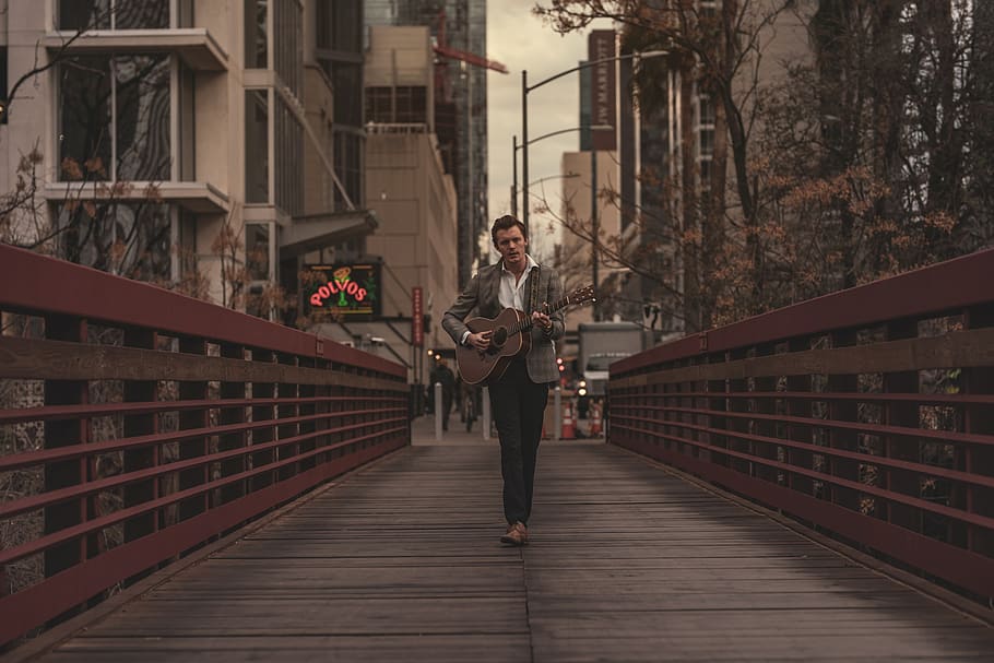Man Playing Guitar in Footbridge, architecture, buildings, city