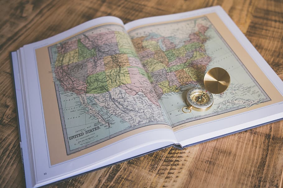 compass on map book page, high angle view, indoors, still life HD wallpaper