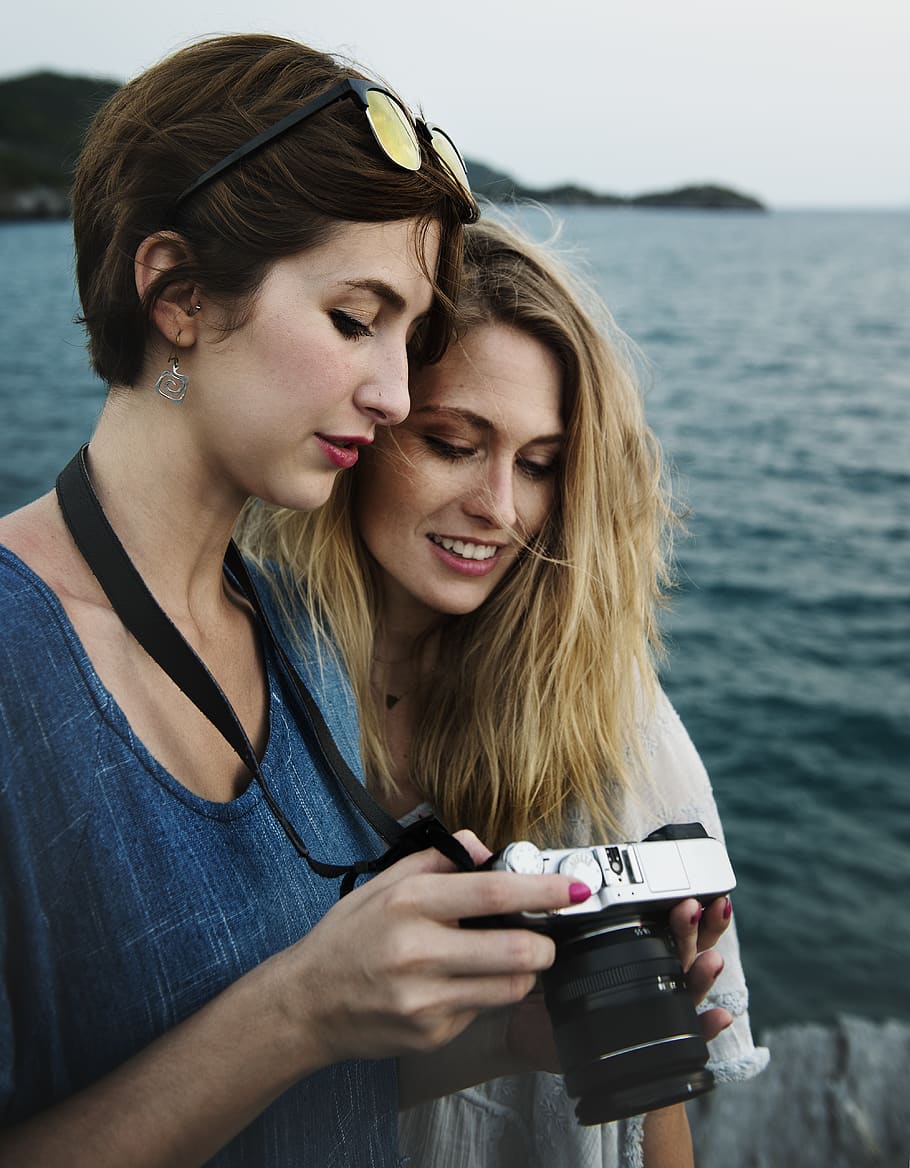 Two Women Looking Captured Photos on Dslr Camera, adventure, beach HD wallpaper