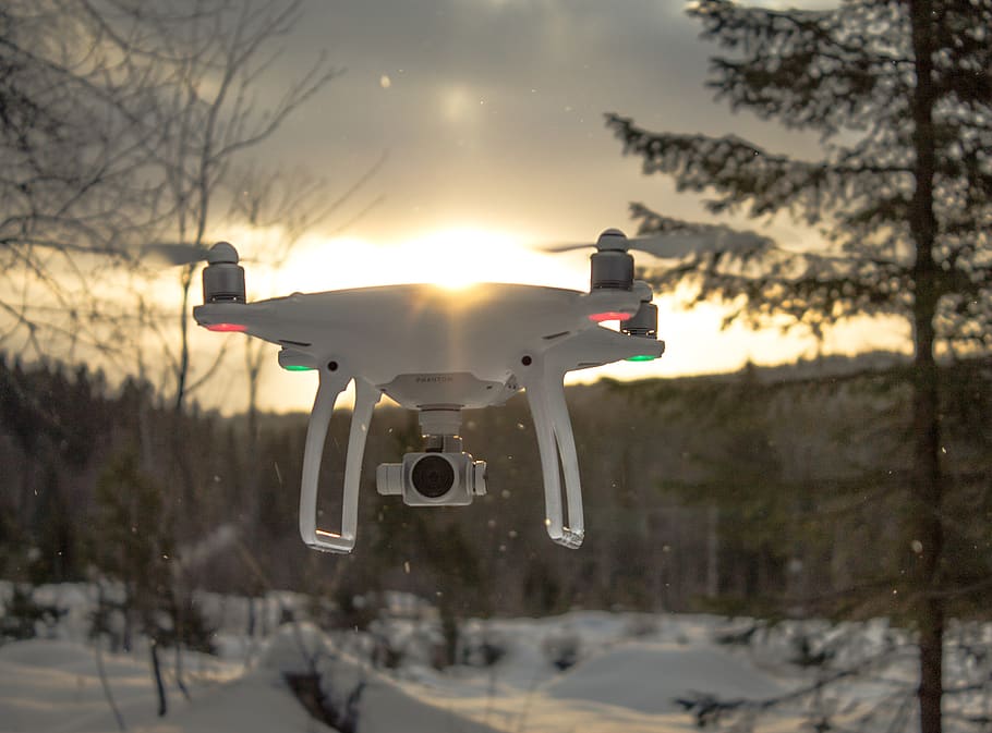 Photo of White Drone Quadcopter Flying Near Trees at Noontime HD wallpaper