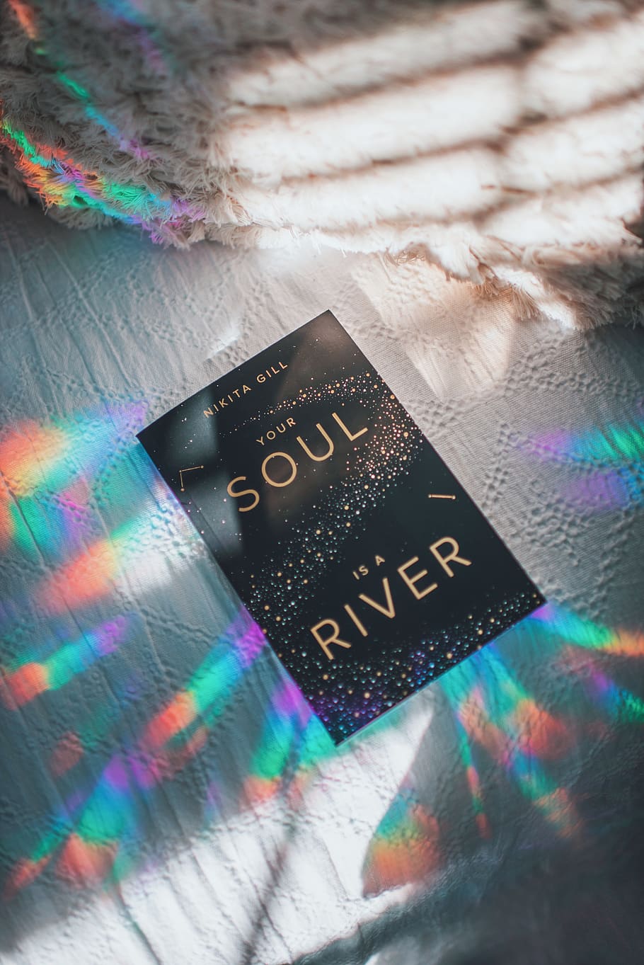 Nikita Gill Your Soul is a River book, sunlight, lights, rainbow