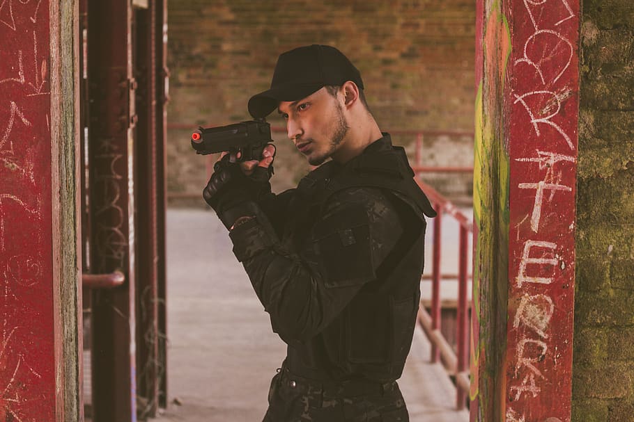Man Using Airsoft Pistol, battle, fun, gun, indoors, person, weapon, HD wallpaper
