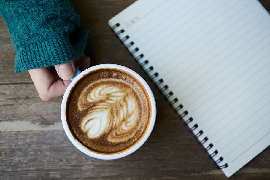 Person Holding White Ceramic Mug Beside Notebook, beverage, brown HD wallpaper