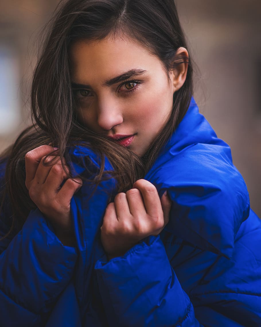 woman wearing blue puffed jacket, one person, young adult, portrait