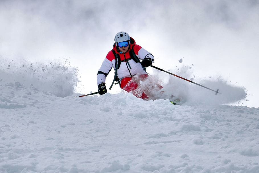 A skier in deep powder snow, skiing with powder ski gear