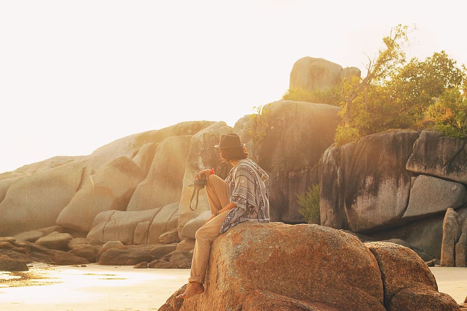 man sitting on rock, person, human, nature, outdoors, photography HD wallpaper