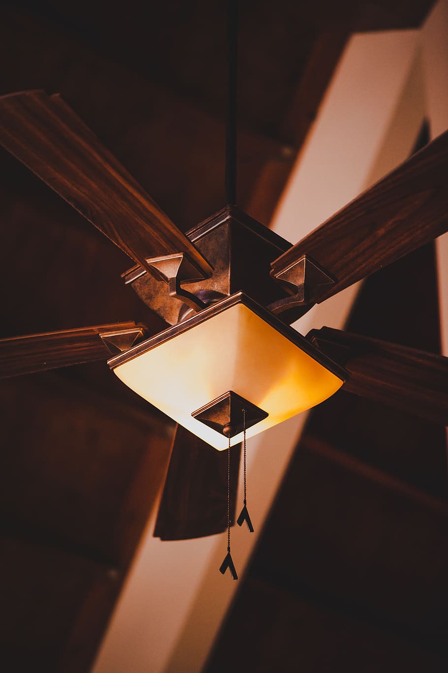 brown 5-blade ceiling fan, light fixture, appliance, ceiling light