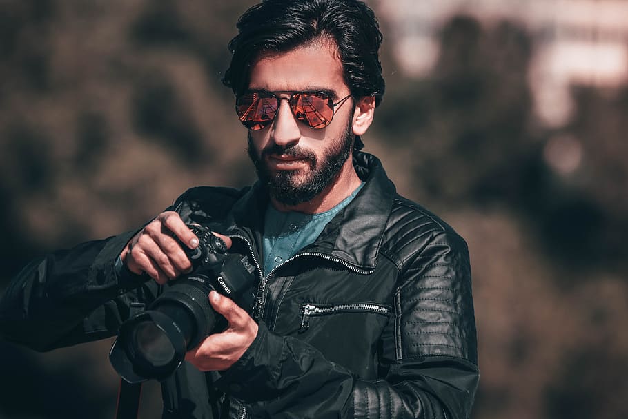 Man Holding Black Canon Dslr Camera, black leather jacket, blurred background HD wallpaper