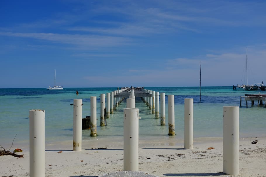 water, ocean, pillars, beach, belize, vacation, sea, sky, horizon HD wallpaper
