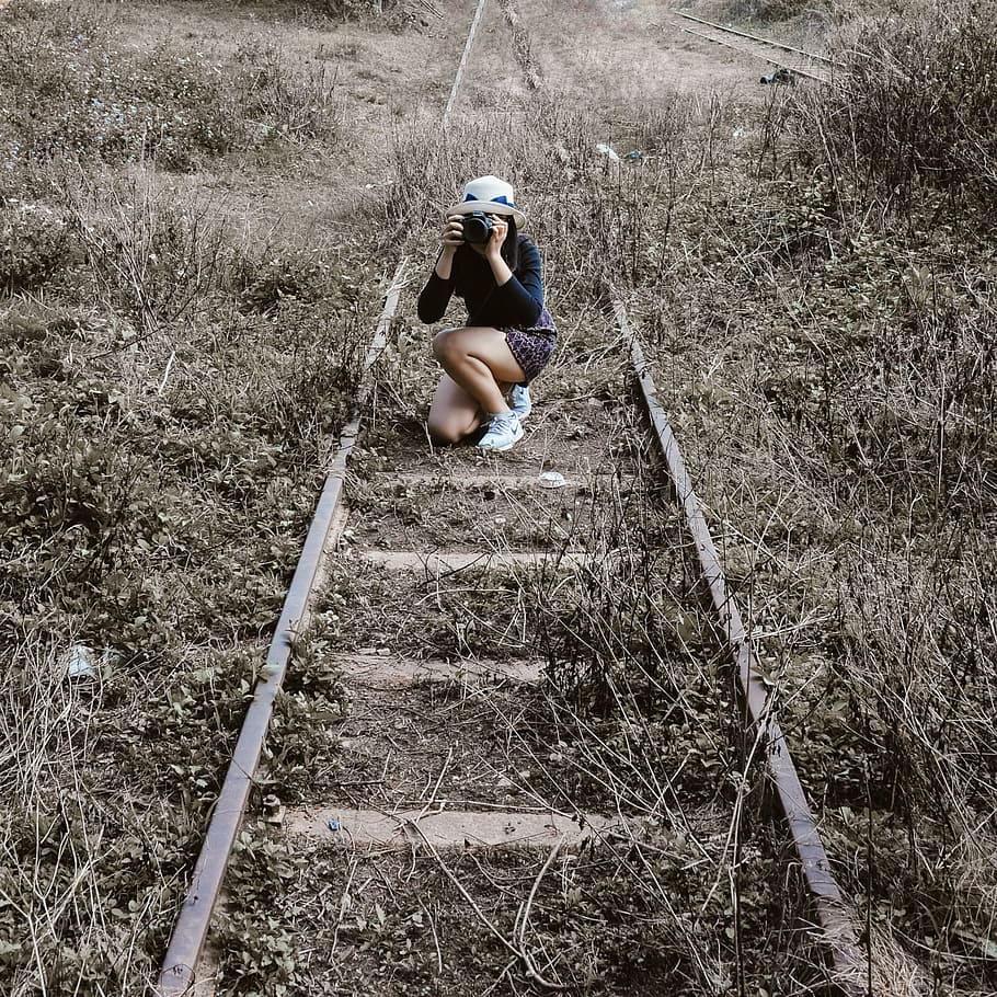 Woman White Round Hat Holding Black Dslr Camera on Rail Way, daylight HD wallpaper