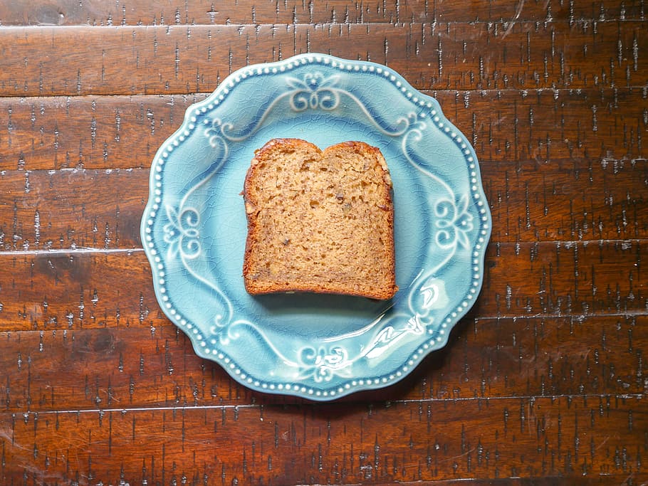 Topview of banana nut bread sitting on a blue plate in the sunlight. HD wallpaper