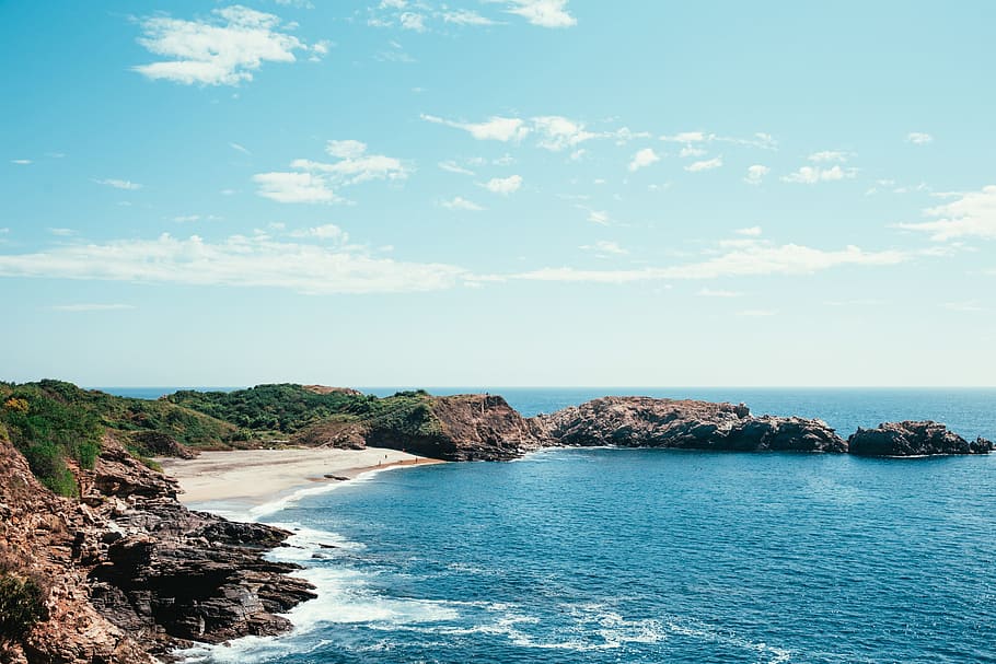 People spending holiday on the beach surrounded by blue ocean