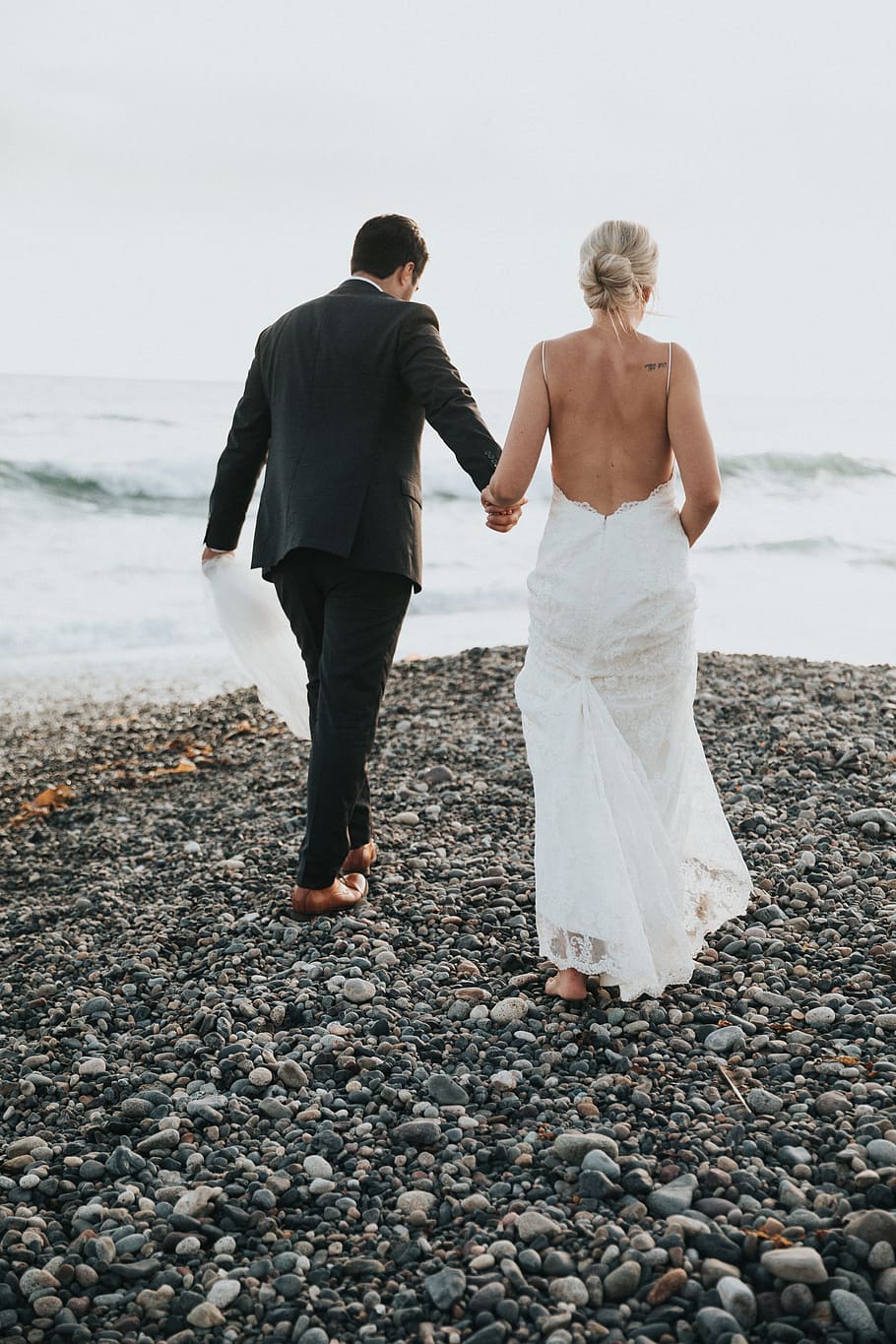 groom and bride walking on stone near body of water, romance HD wallpaper