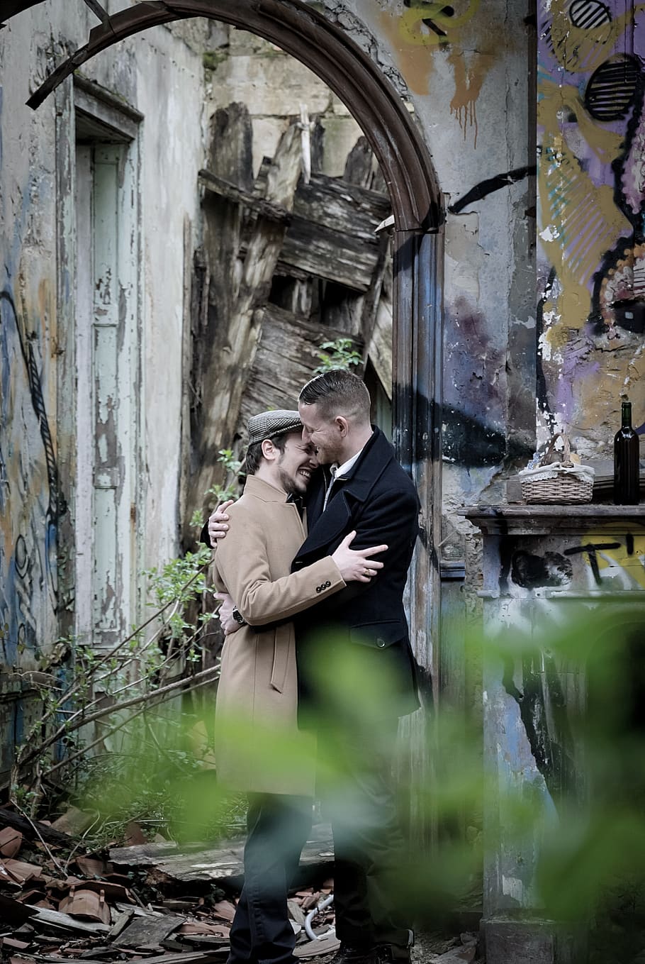 Man Embracing Man Near Gray Wall, abandoned, adult, building