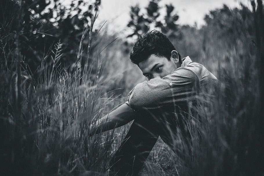 Monochrome Photo Of Man Sitting On Grass, black-and-white, blur