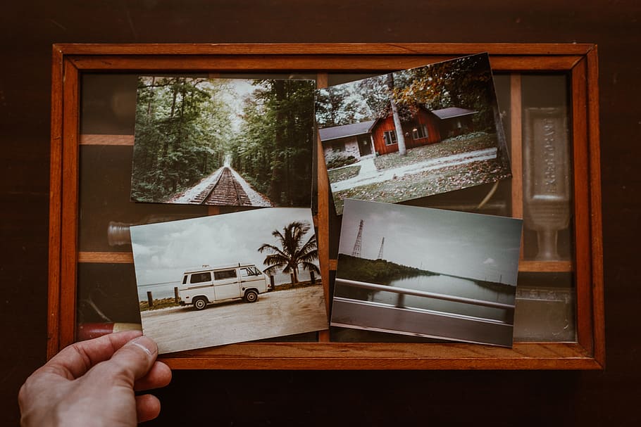 person holding four photos, print, memories, holiday, vacation