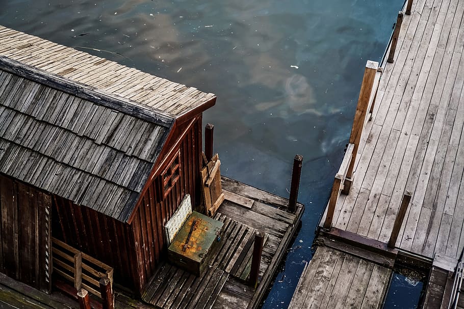aerial photograph of brown house, building, dock, bay, water