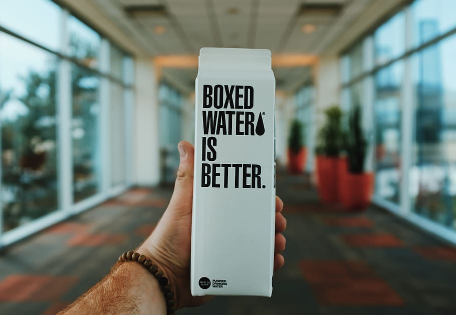 person holding boxed water is better box, hand, label, design HD wallpaper