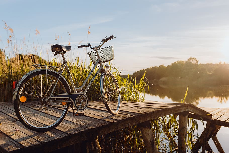Bicycle with basket on the pier in bright sunset light, evening, HD wallpaper