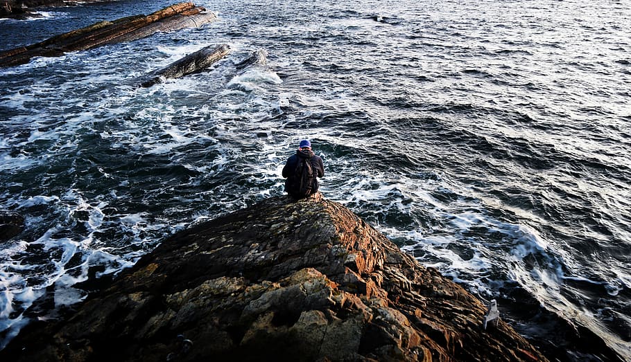 Photography of Person Sitting on Rock Near Ocean, beach, environment HD wallpaper