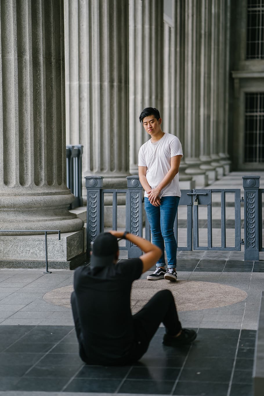 Man Sitting While Taking Picture Of Another Man , men, people HD wallpaper