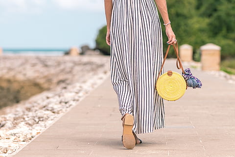 Woman Wearing Black and White Striped Maxi Skirt Holding Brown Bag HD wallpaper