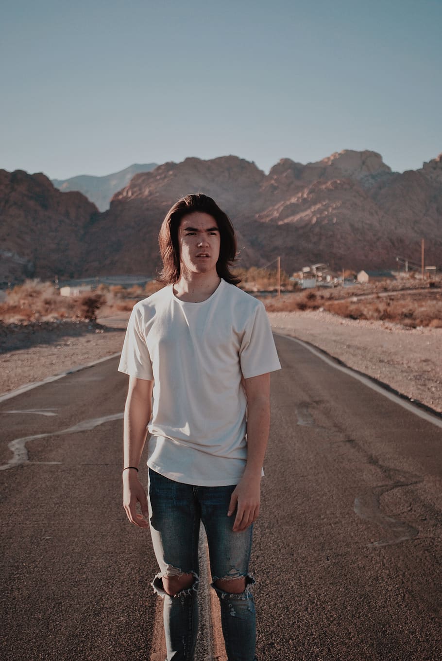 man wearing white tee shirt and tattered jeans standing on road, HD wallpaper