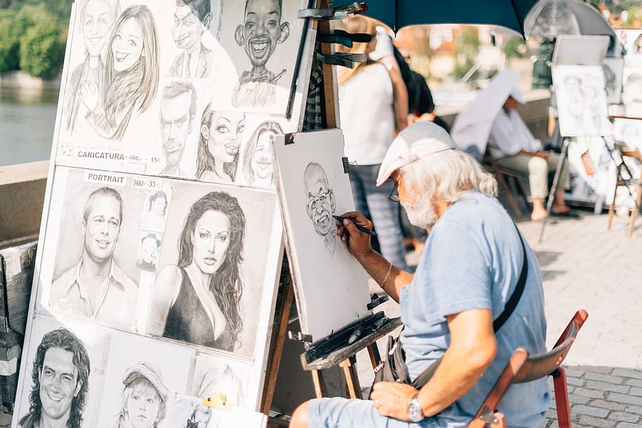 man sitting on chair sketching a person's face, people, human