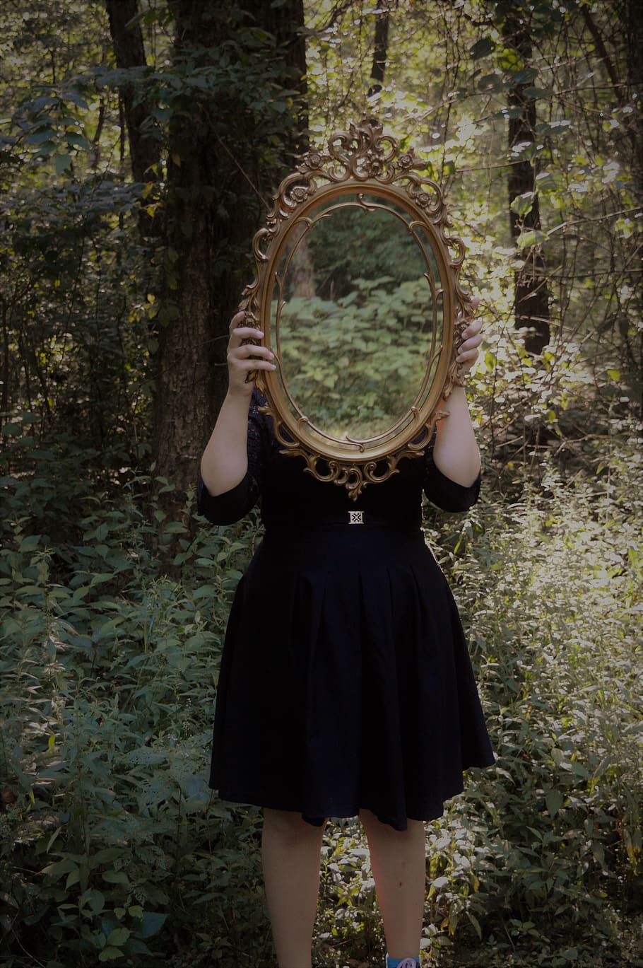 Woman Holding Mirror Against Her Head in the Middle of Forest HD wallpaper