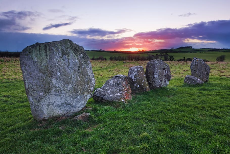 Rock Formation on Green Grass Field, ancient, backlit, clouds HD wallpaper