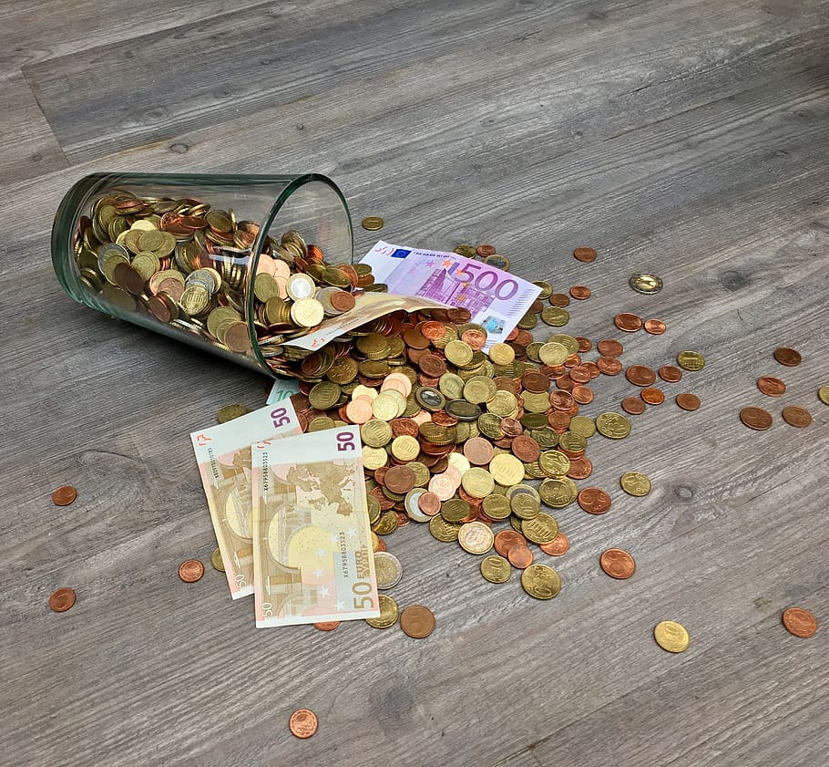 Coins and Banknotes Scattered on Gray Wooden Surface, capital