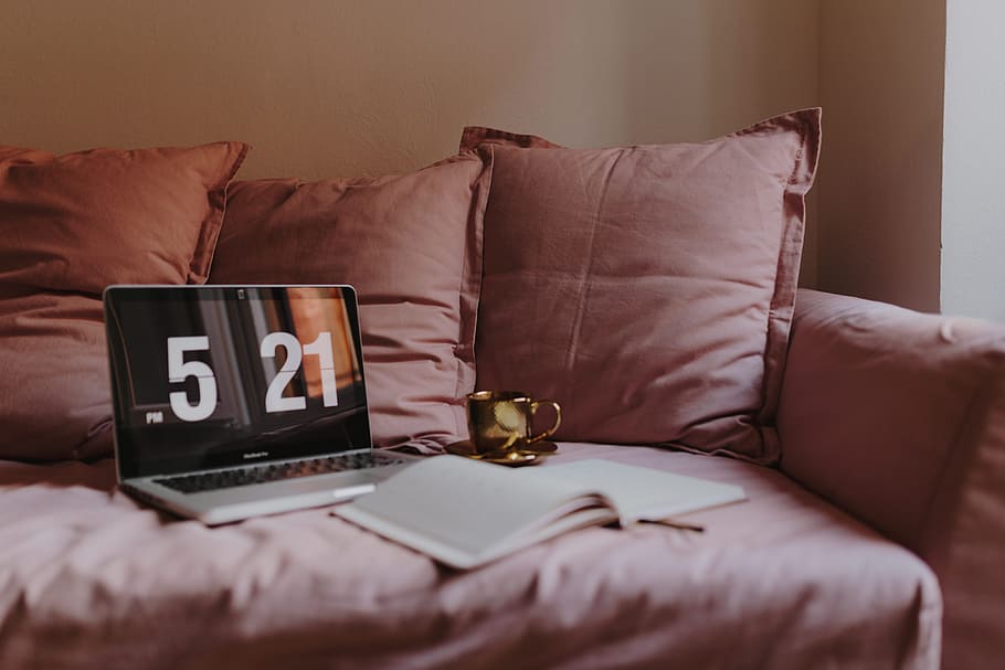 Workplace with a laptop on a pink couch, macbook, macbook pro HD wallpaper