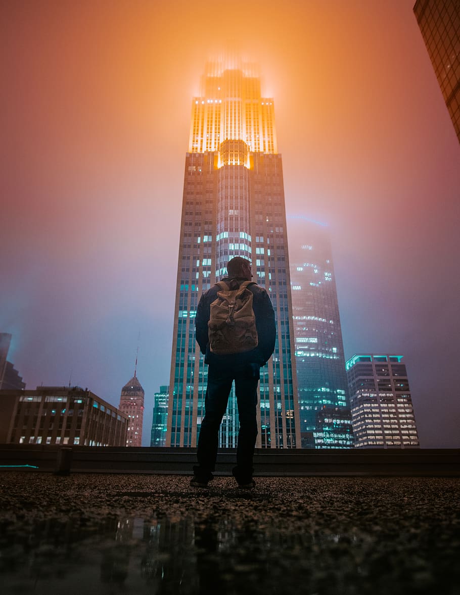 man standing while facing building, urban, city, metropolis, town HD wallpaper