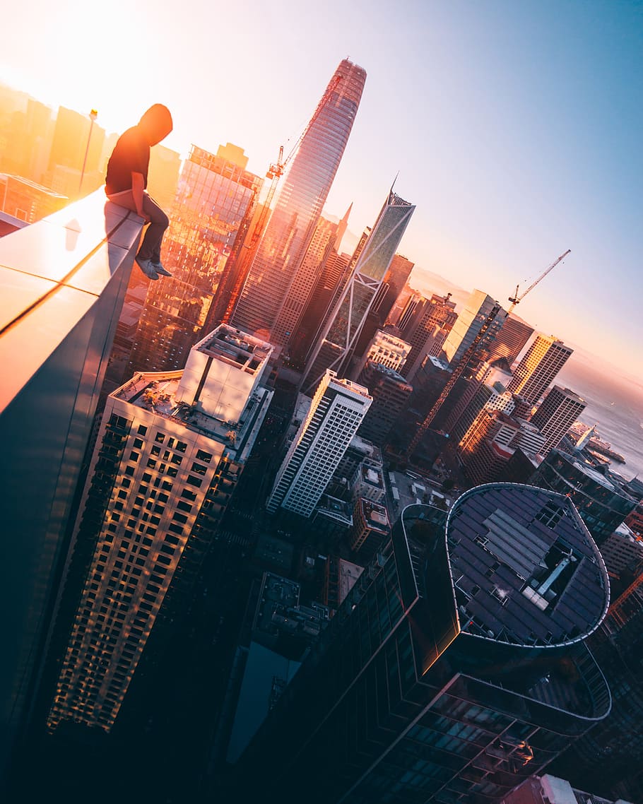 person sitting on top of building during daytime, man, male, sunset