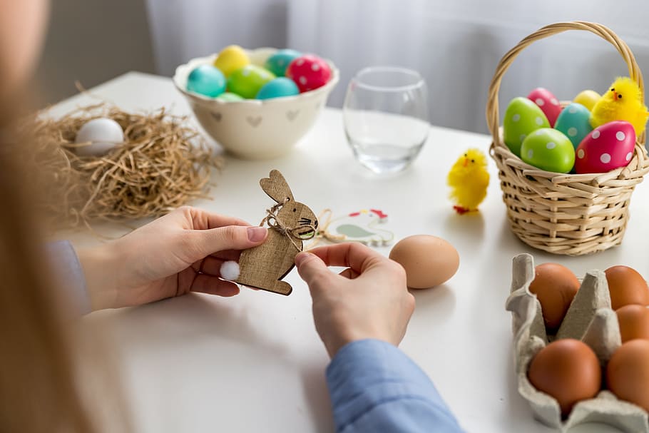 Female hands made some wooden easter ornaments. Happy Easter! HD wallpaper