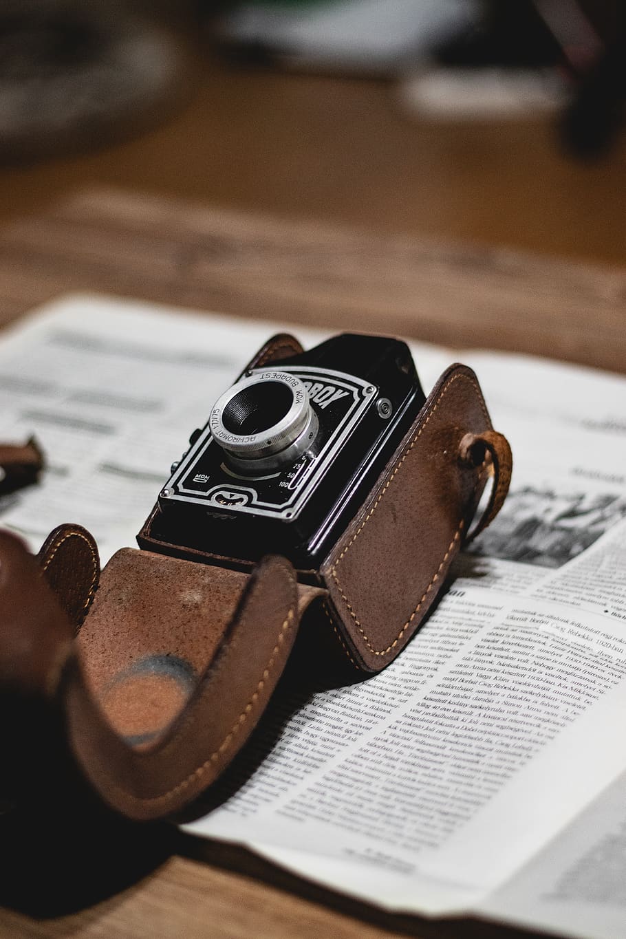 black camera with brown leather case on book, strap, electronics HD wallpaper