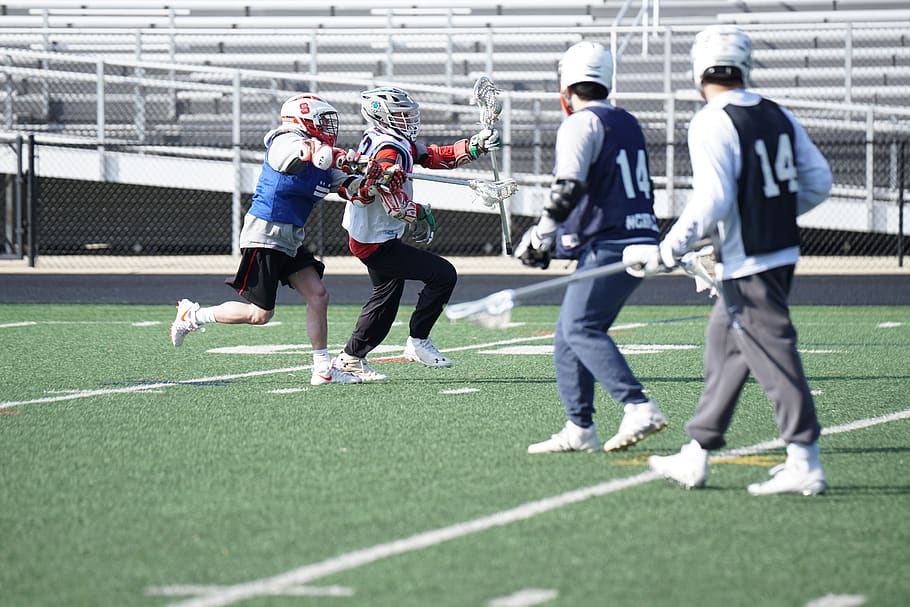 four men playing lacrosse, person, human, apparel, clothing, helmet