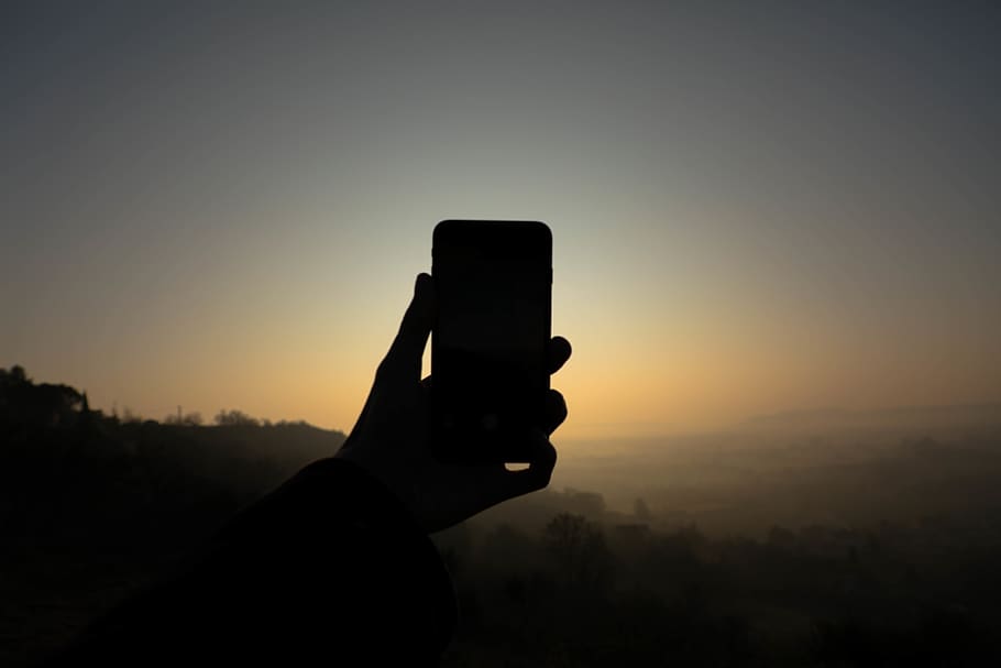 sun, sunset, iphone, forest, fog, hand, human hand, sky, wireless technology HD wallpaper